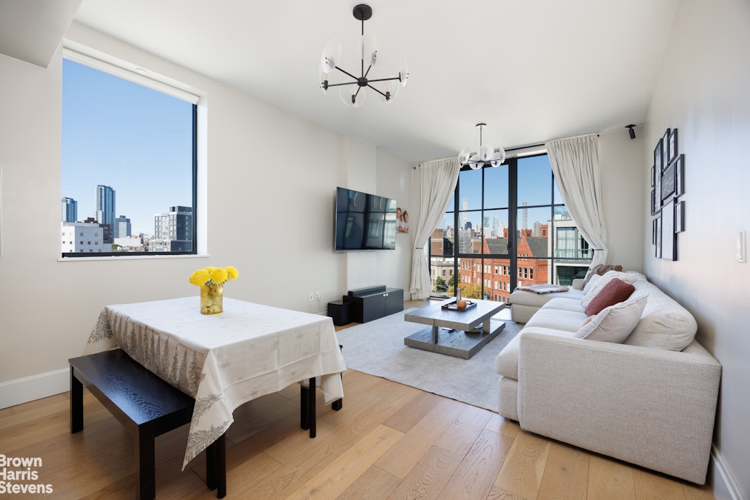 a living room with furniture a flat screen tv and a table