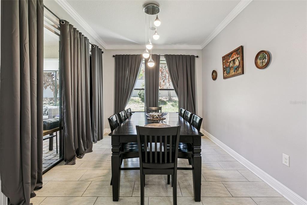 2541 Red Berry Way Ocoee, FL 34761 - Photo 11 of 49 a view of a dining room with furniture and window