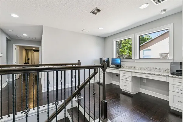 a bedroom with a bed chandelier and a window