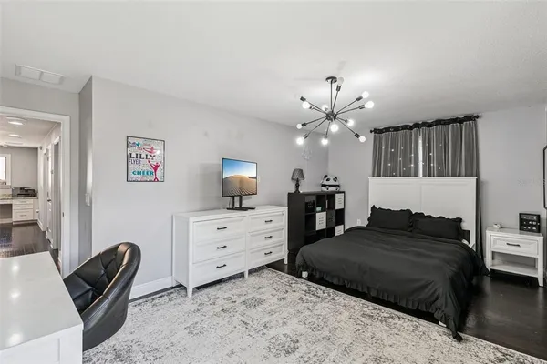 a bedroom with a bed and a chandelier