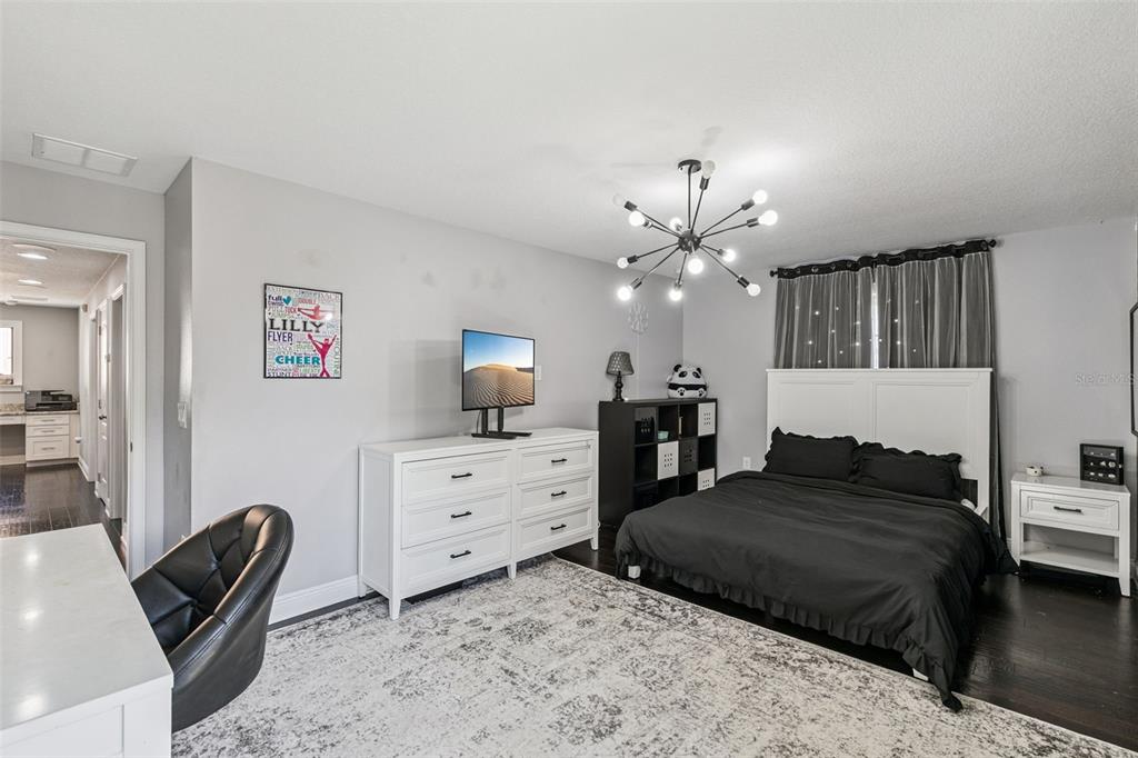 2541 Red Berry Way Ocoee, FL 34761 - Photo 17 of 49 a bedroom with a bed chandelier and a window