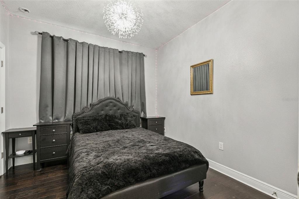 2541 Red Berry Way Ocoee, FL 34761 - Photo 18 of 49 a bedroom with a bed and a chandelier