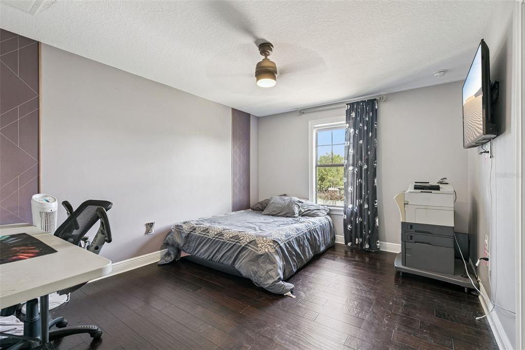 2541 Red Berry Way Ocoee, FL 34761 - Photo 19 of 49 a bedroom with a bed and a flat screen tv