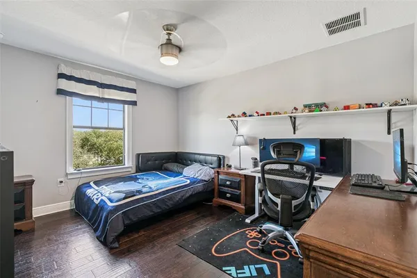 a bedroom with a bed and a desk