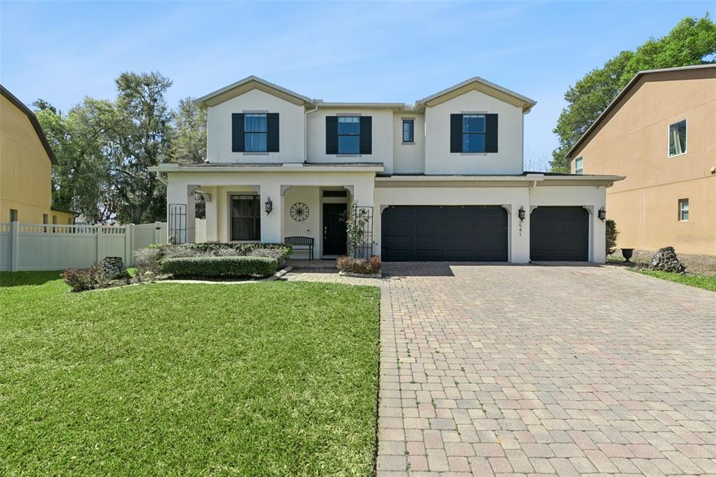2541 Red Berry Way Ocoee, FL 34761 - Photo 2 of 49 a front view of a house with a yard and garage