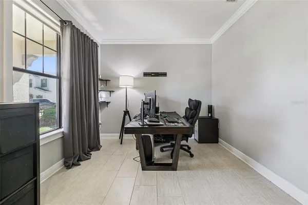 a living room with furniture and a floor to ceiling window