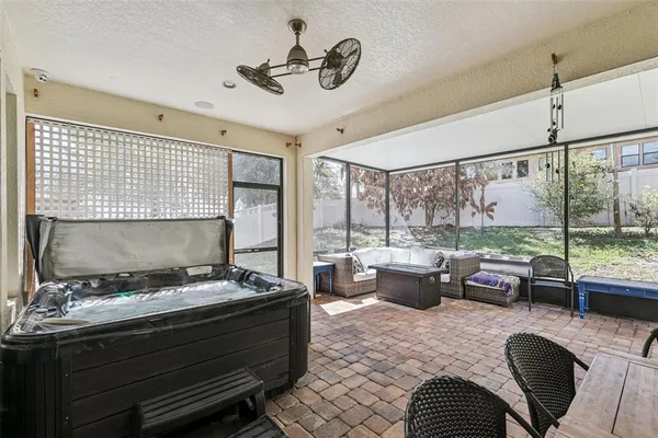 a living room with furniture a large window and a fireplace