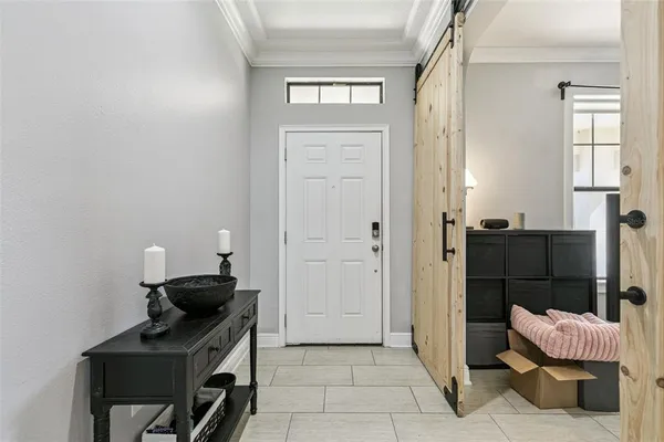 a view of a hallway with closet and a fireplace