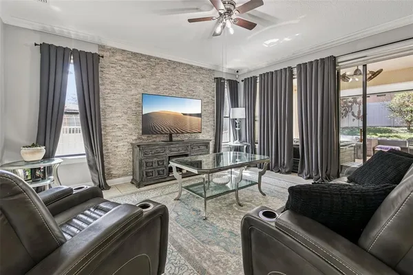 a living room with furniture and a flat screen tv with wooden floor