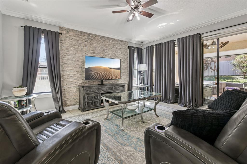 2541 Red Berry Way Ocoee, FL 34761 - Photo 10 of 49 a living room with furniture and a flat screen tv with wooden floor