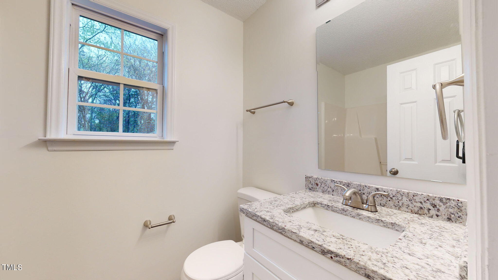 4805 Topstone Road Raleigh, NC 27603 - Photo 38 of 43 a bathroom with a granite countertop toilet sink and mirror