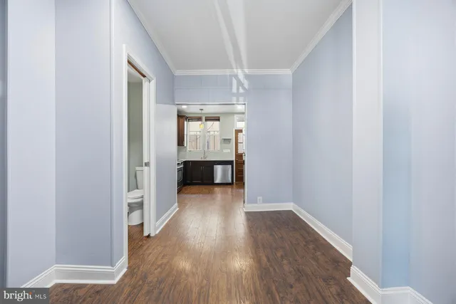 a view of hallway with wooden floor