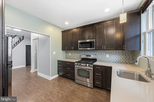 a kitchen with a sink cabinets and stainless steel appliances