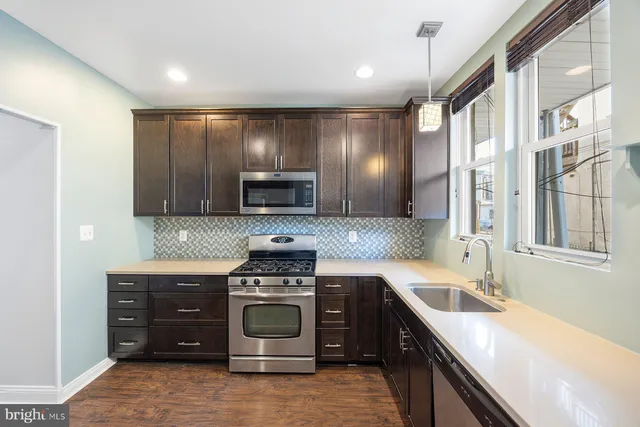 a kitchen with a stove sink and microwave