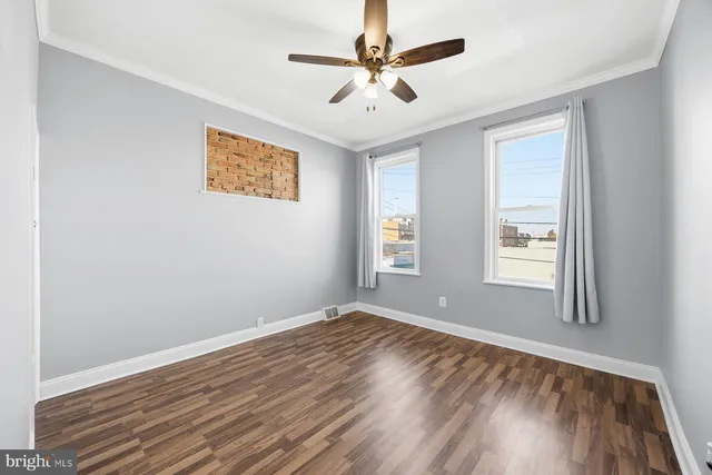 wooden floor in an empty room with a window