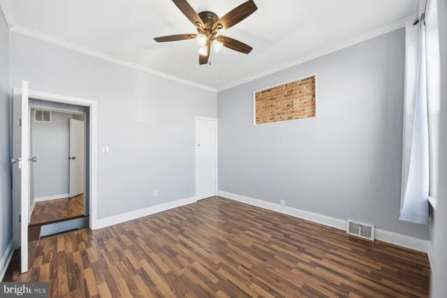 wooden floor in an empty room with a window