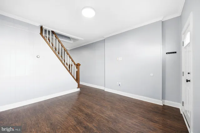 a view of room with stairs and wooden floor