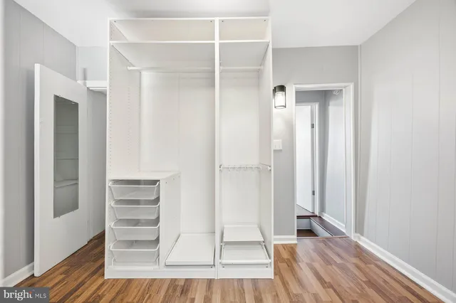 a view of walk in closet with empty racks