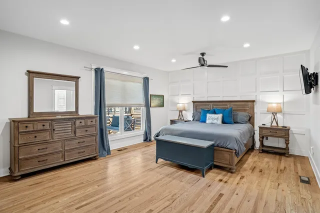 a spacious bedroom with a large bed and a dresser