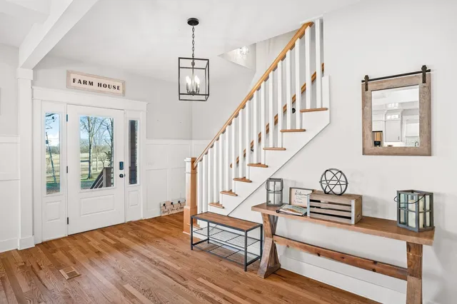 a view of entryway and hall with wooden floor
