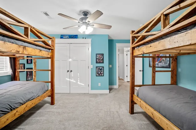 a bedroom with a large bed and a chandelier