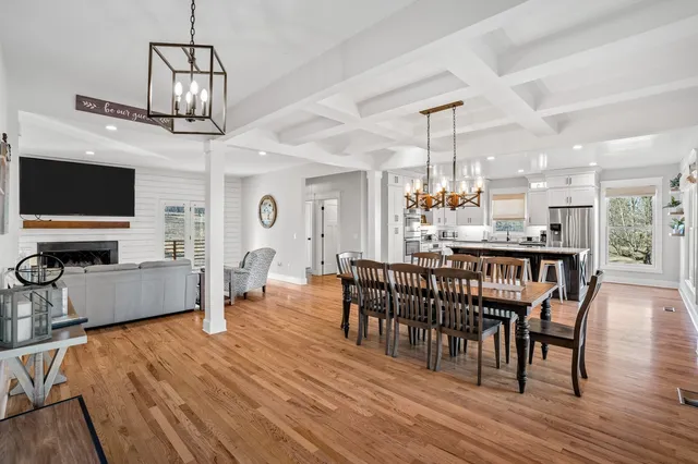 a view of a dining room with furniture wooden floor and chandelier
