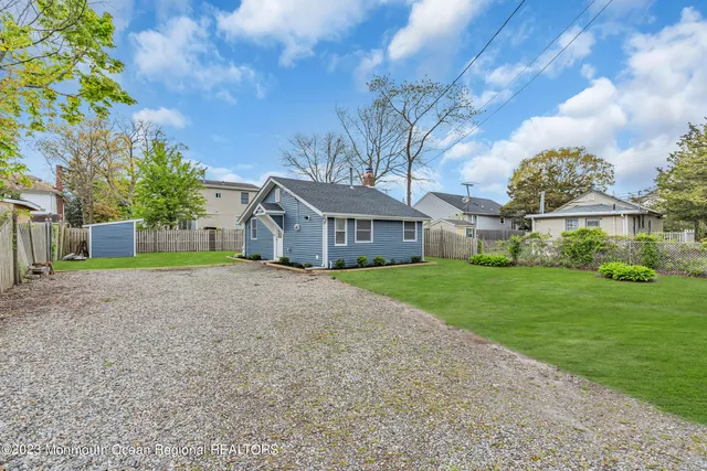 a view of a yard with a wooden fence
