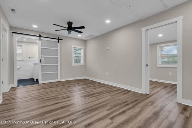 wooden floor in an empty room with a window