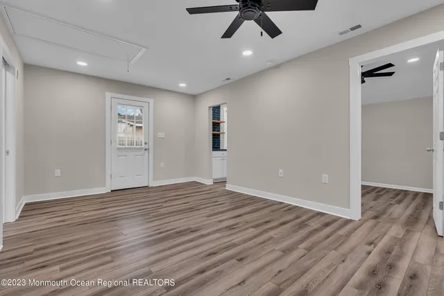 a view of empty room with wooden floor