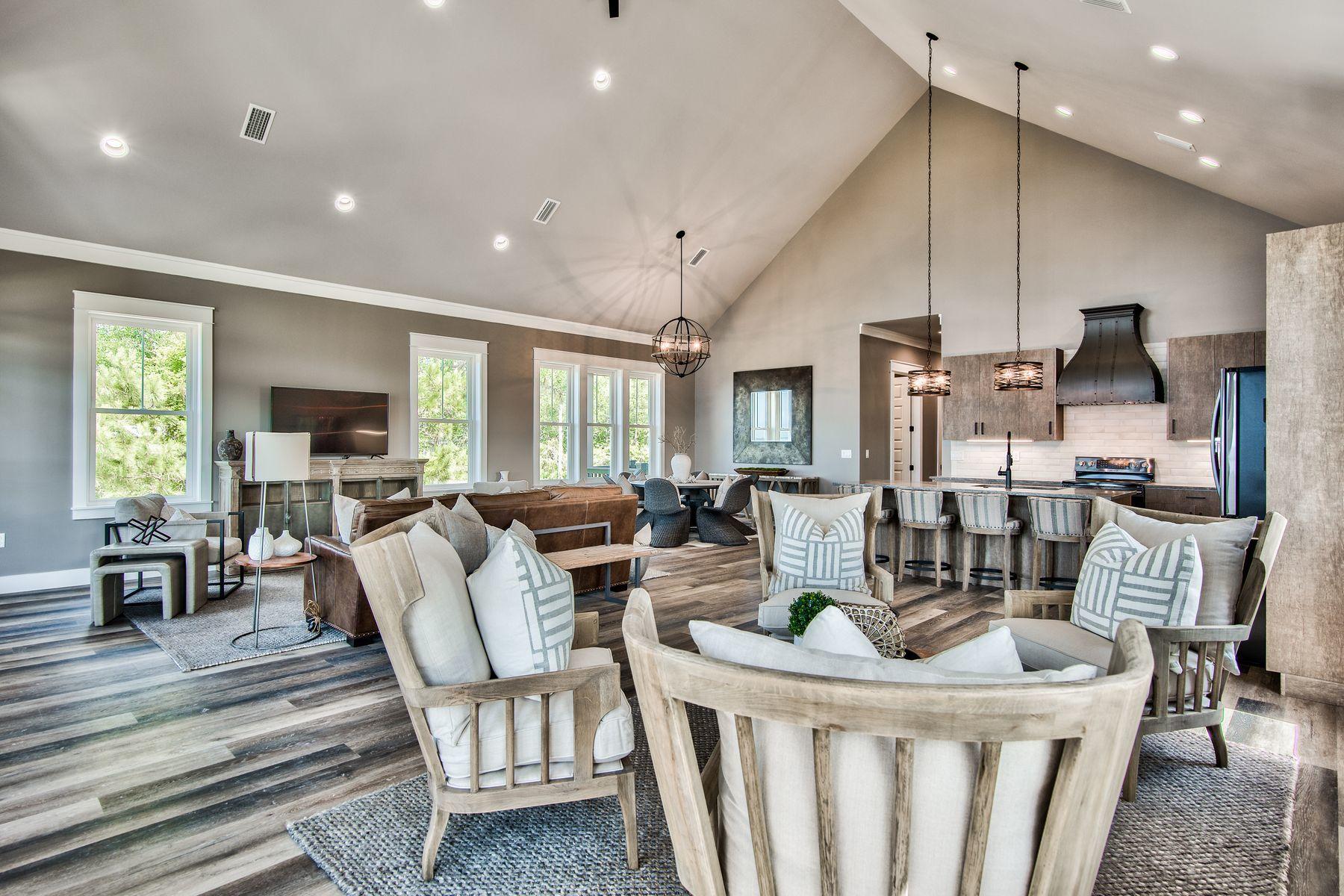 474 Beatrice Point Road Freeport, FL 32439 - Photo 13 of 69 a living room with furniture a flat screen tv and a floor to ceiling window