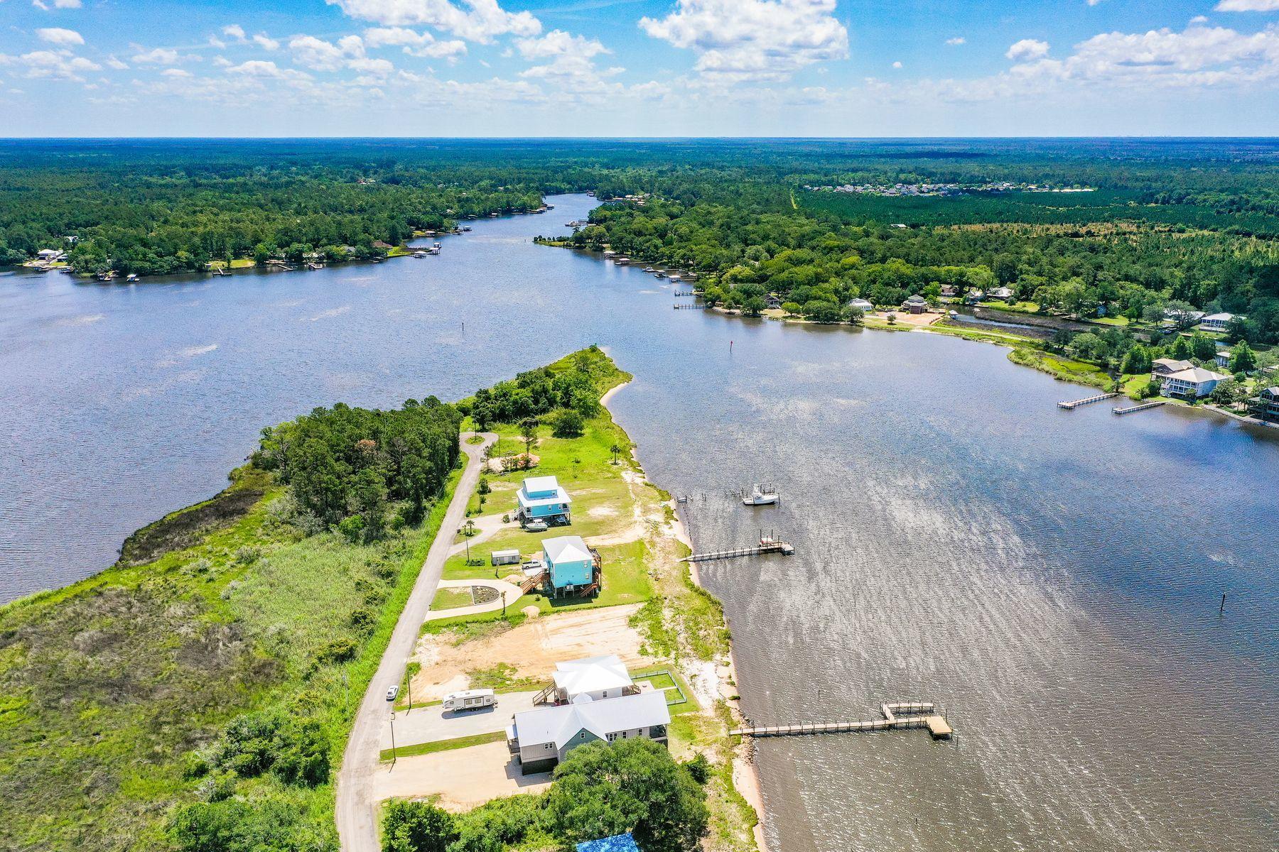 474 Beatrice Point Road Freeport, FL 32439 - Photo 24 of 69 an aerial view of a house with a yard and lake view