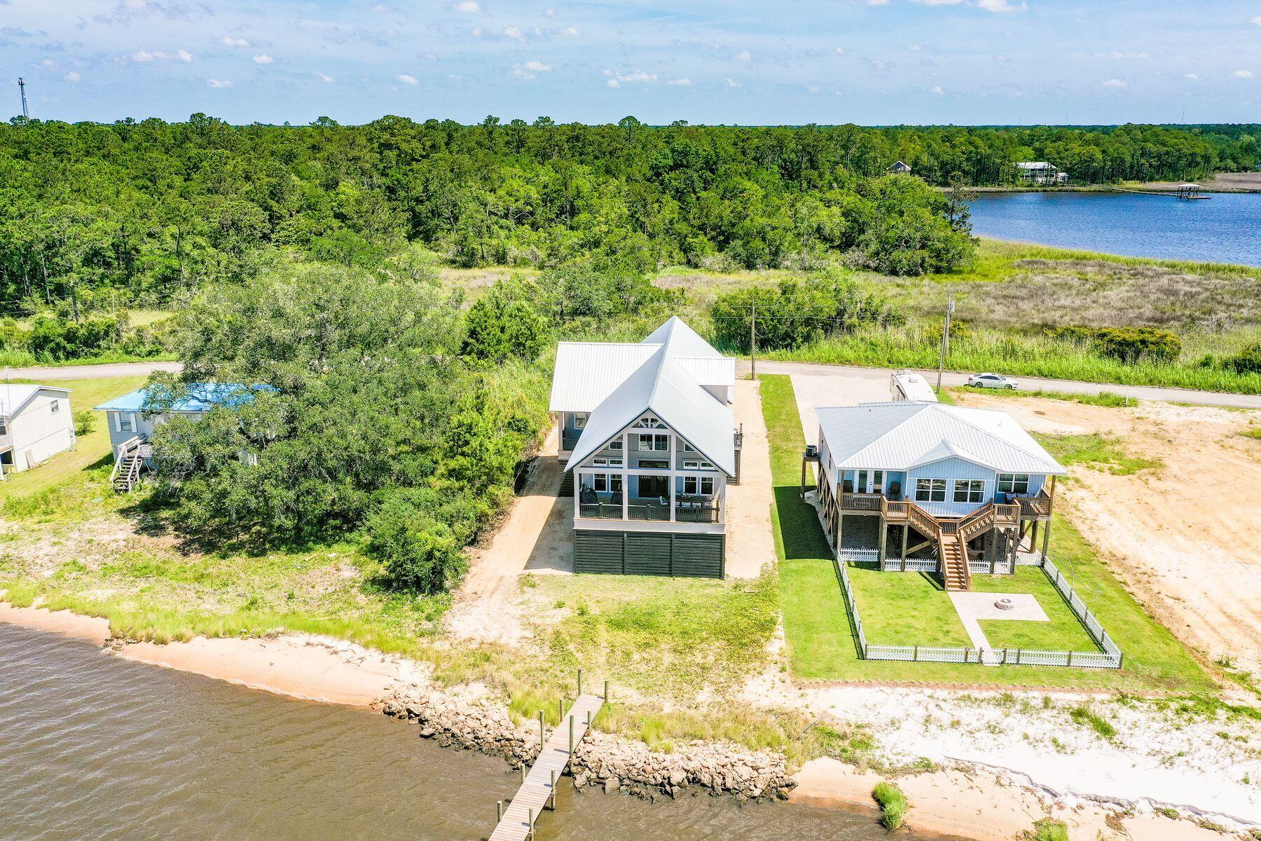 474 Beatrice Point Road Freeport, FL 32439 - Photo 26 of 69 an aerial view of a house with a yard and lake view