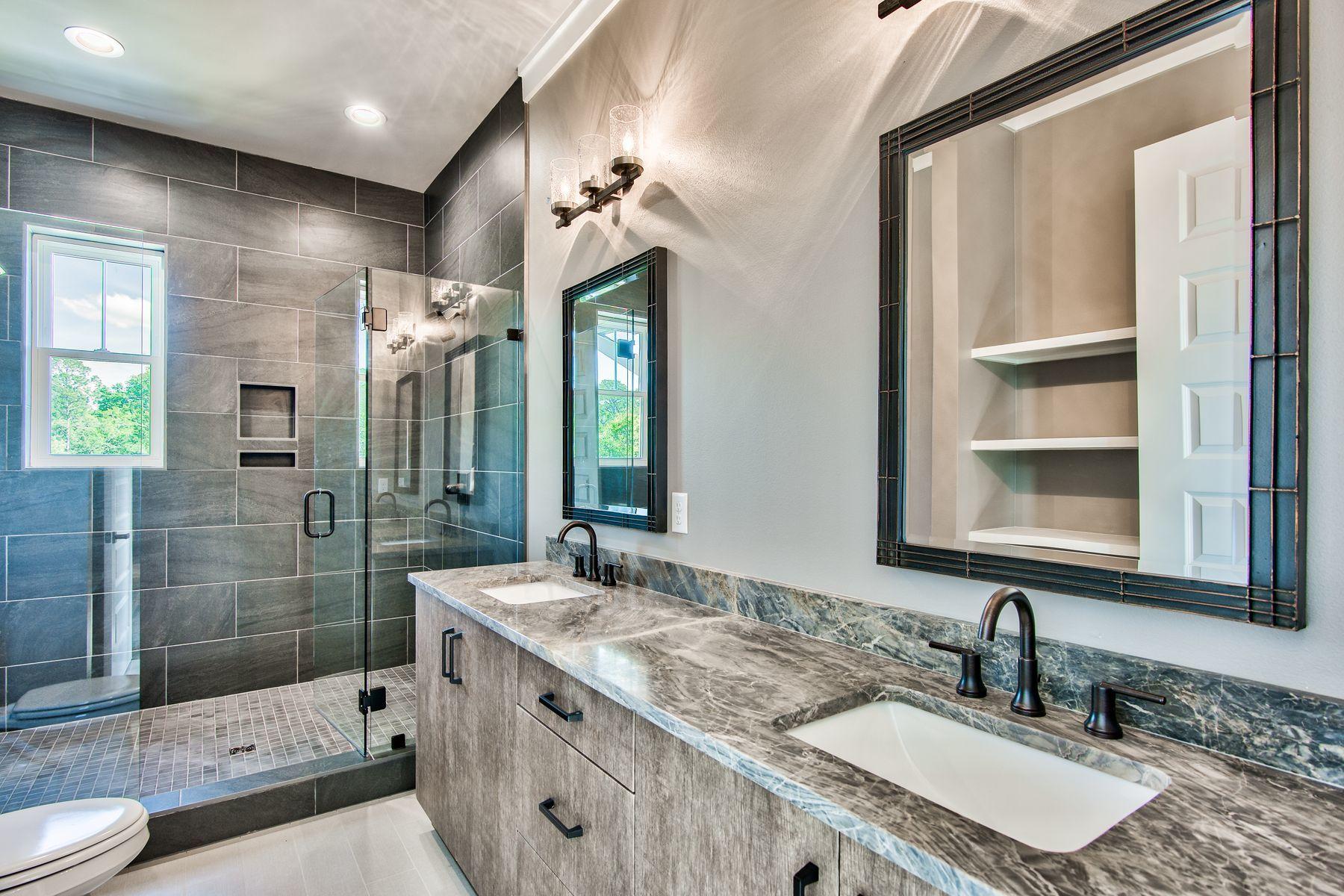 474 Beatrice Point Road Freeport, FL 32439 - Photo 35 of 69 a bathroom with a sink double vanity and a shower