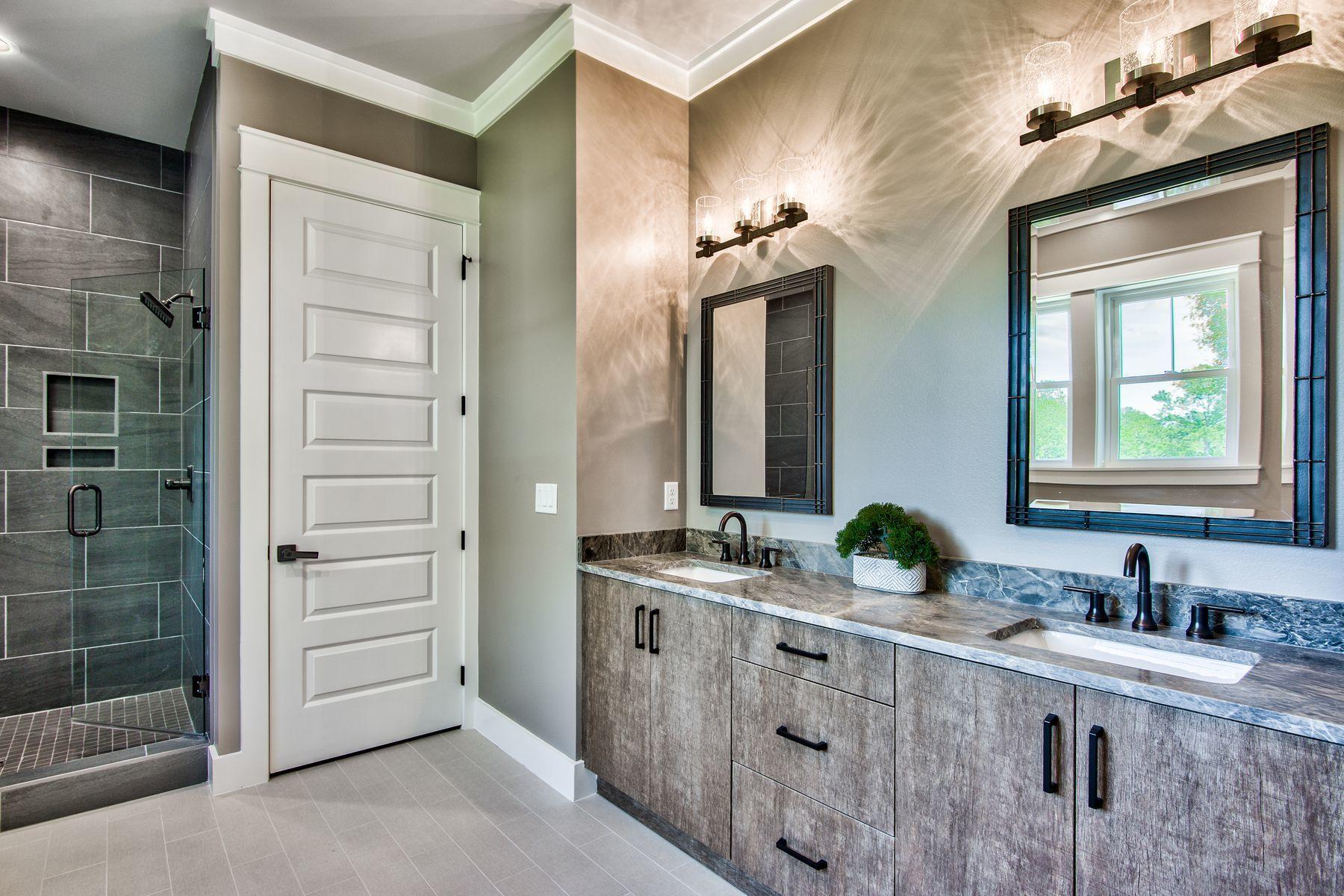 474 Beatrice Point Road Freeport, FL 32439 - Photo 40 of 69 a bathroom with a double vanity sink a mirror and shower