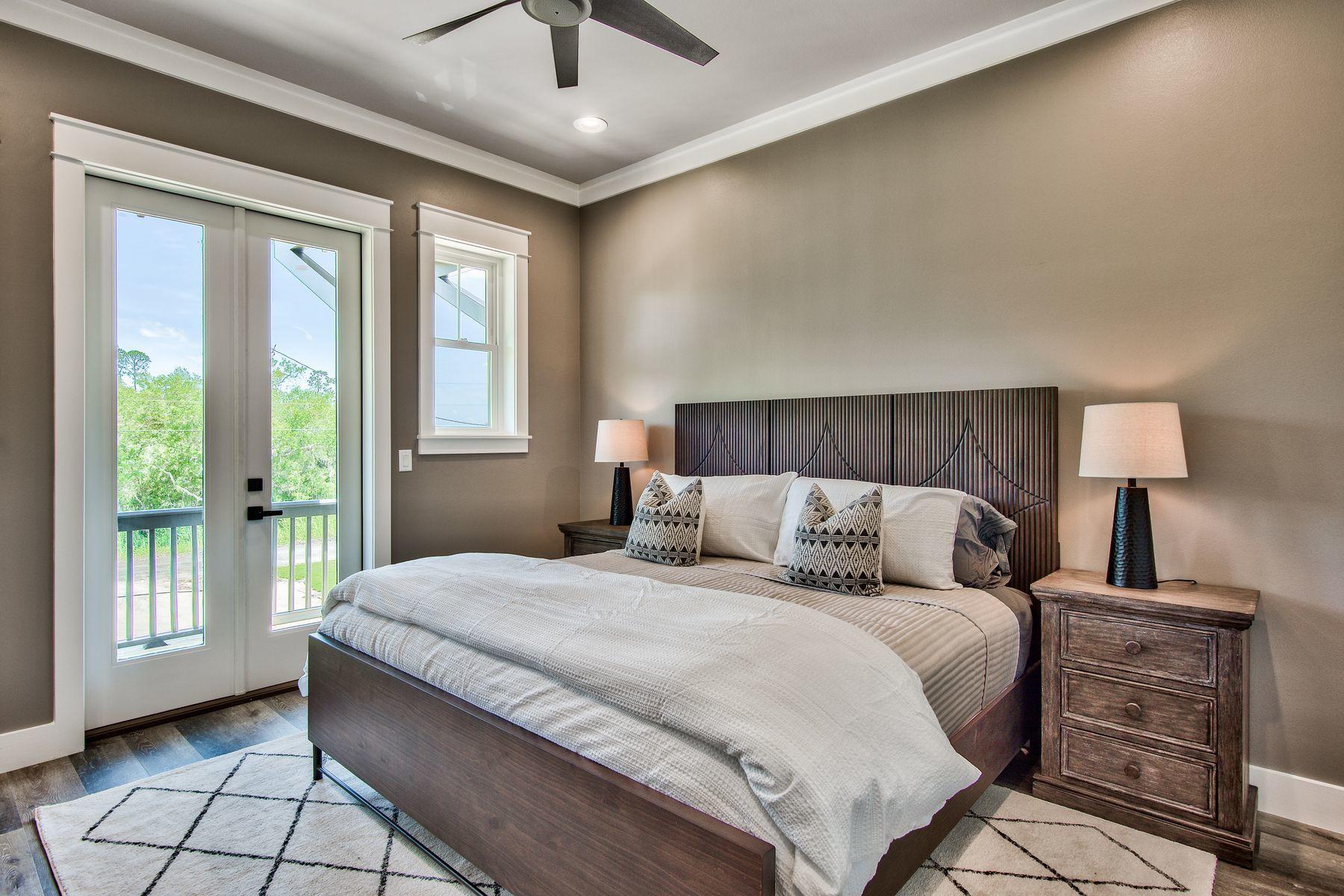 474 Beatrice Point Road Freeport, FL 32439 - Photo 43 of 69 a bedroom with a large bed and a window