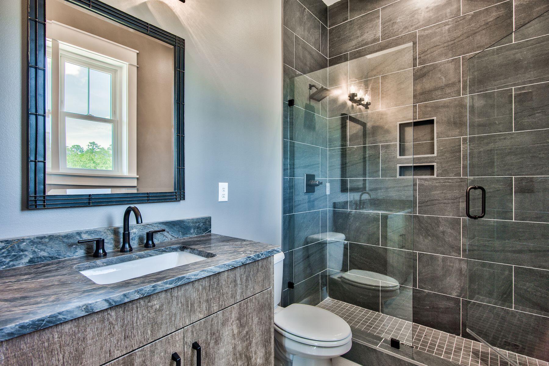 474 Beatrice Point Road Freeport, FL 32439 - Photo 44 of 69 a bathroom with a granite countertop sink a toilet and shower