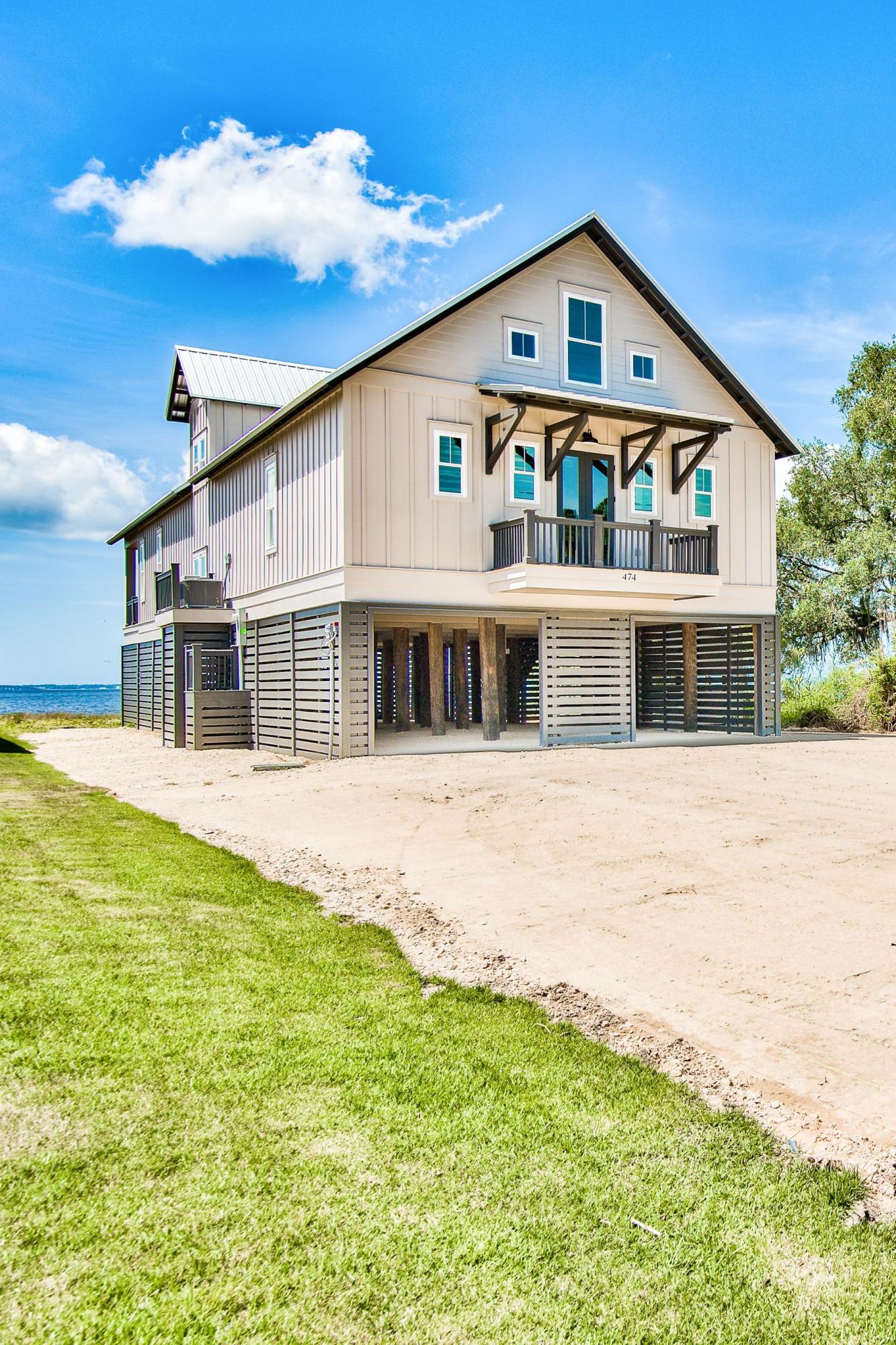 474 Beatrice Point Road Freeport, FL 32439 - Photo 67 of 69 a front view of a house with a yard