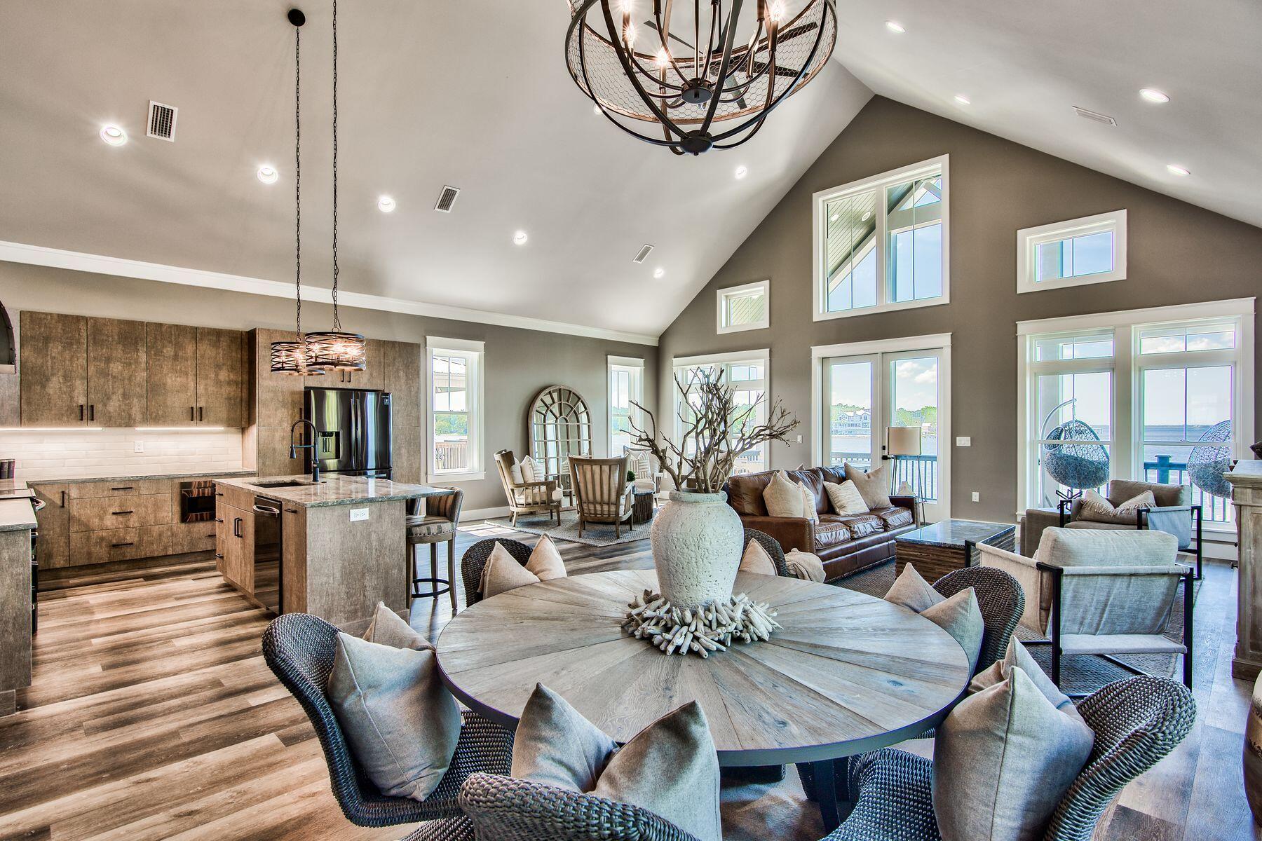 474 Beatrice Point Road Freeport, FL 32439 - Photo 7 of 69 a view of a dining room with furniture large windows and wooden floor