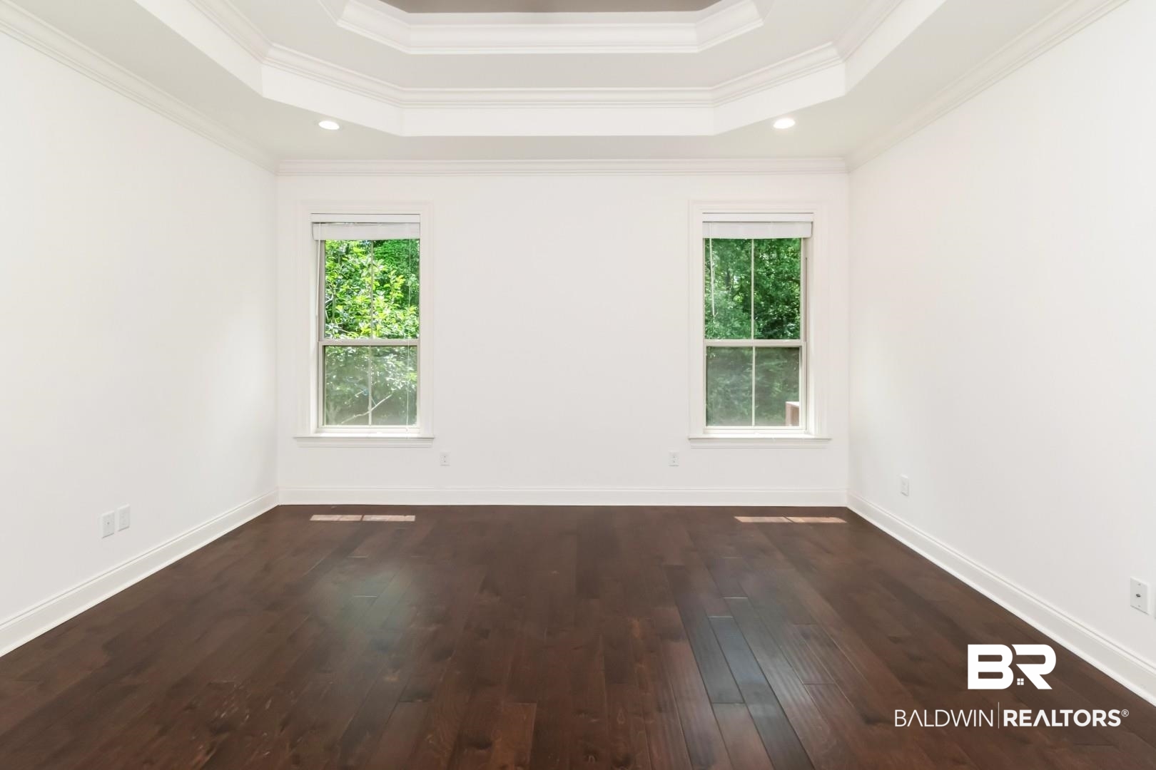 3528 Rue Royal Mobile, AL 36693 - Photo 24 of 53 Spacious room featuring rich wood-finish flooring, a coffered ceiling with recessed lighting, and two double-hung windows