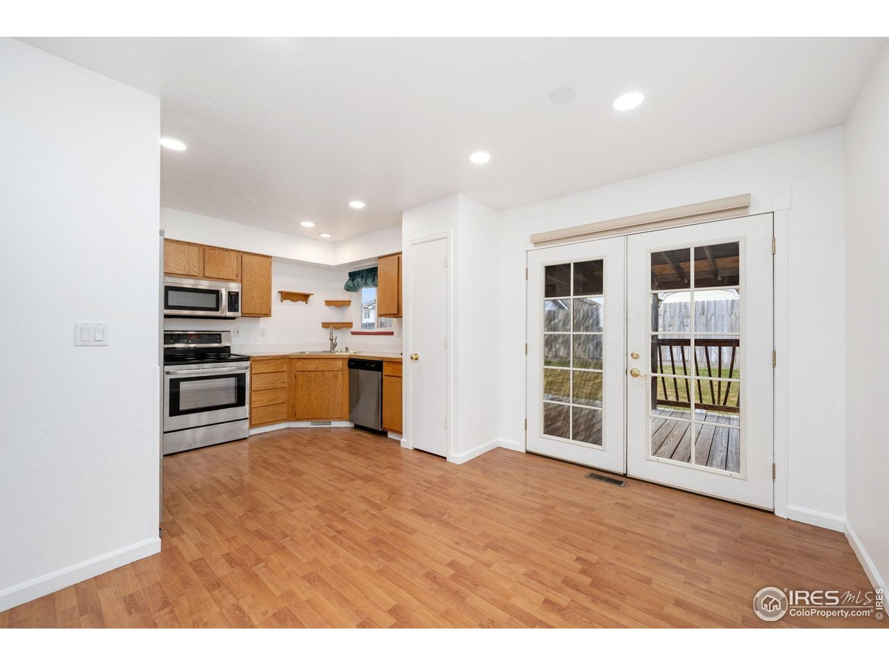 4616 Homestead Court Greeley, CO 80634 - Photo 11 of 22 a kitchen with a refrigerator and a sink