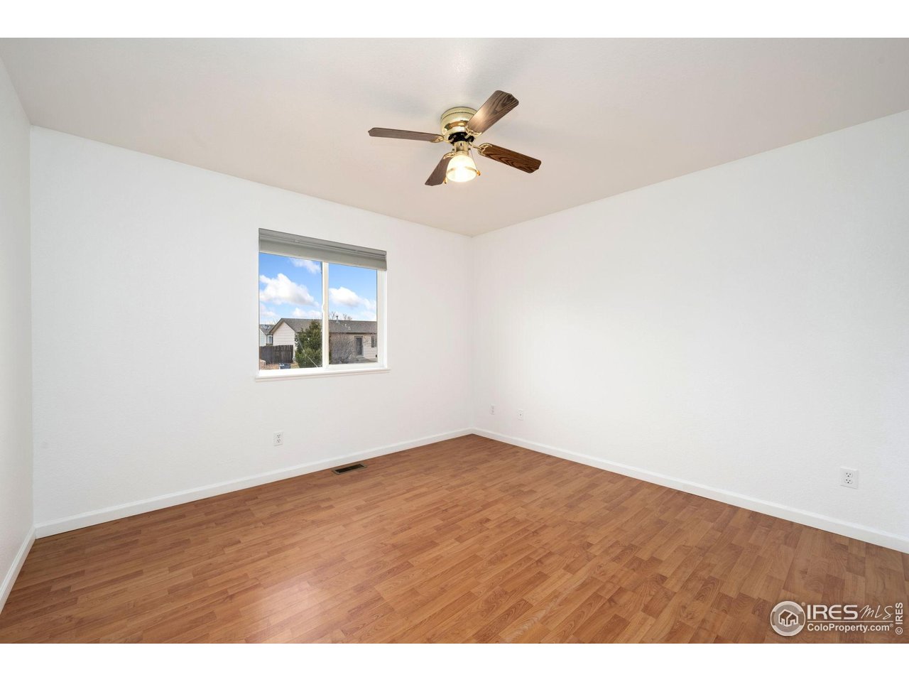 4616 Homestead Court Greeley, CO 80634 - Photo 12 of 22 a view of empty room with wooden floor
