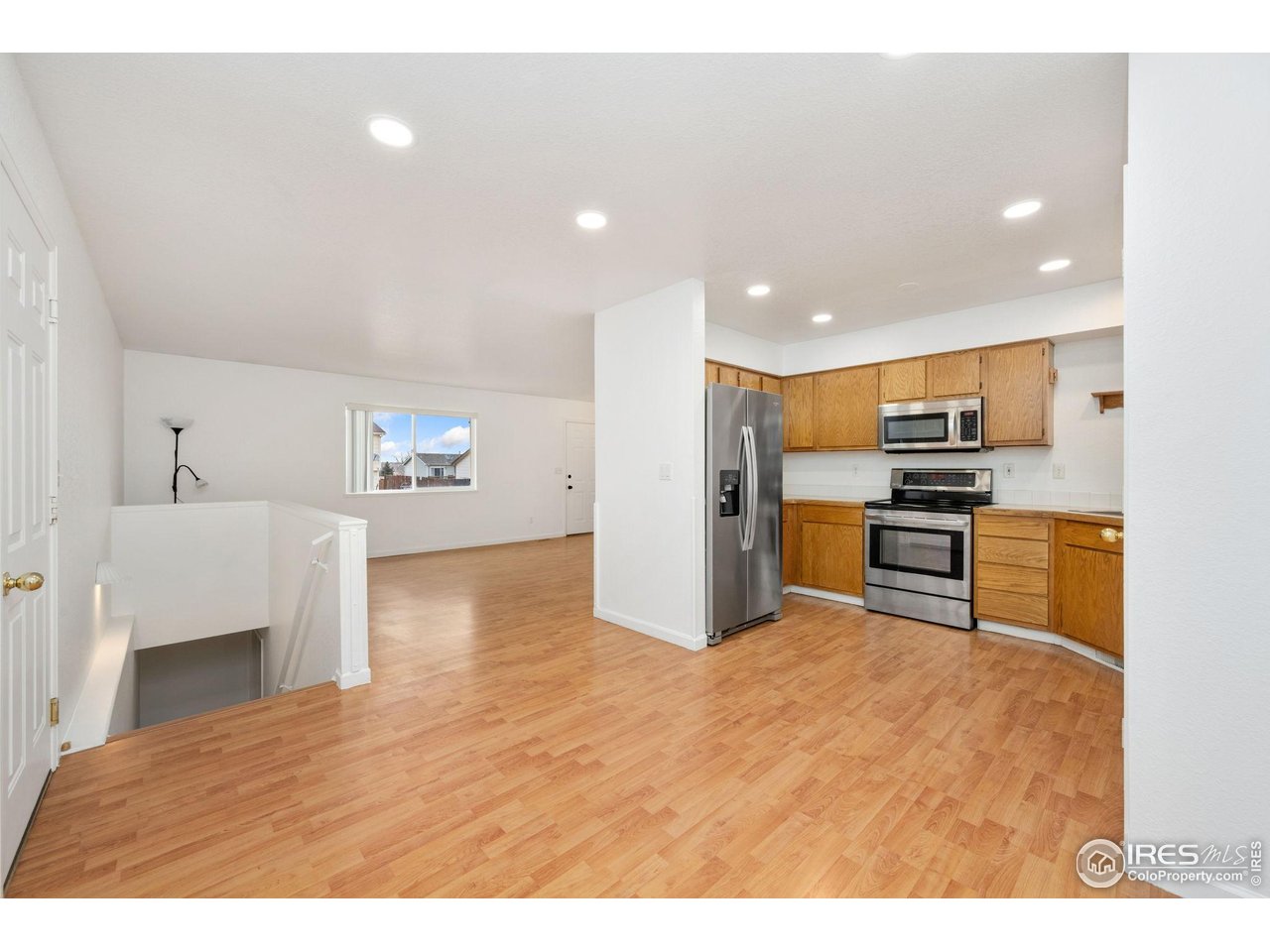 4616 Homestead Court Greeley, CO 80634 - Photo 7 of 22 a kitchen with stainless steel appliances kitchen island granite countertop a refrigerator and stove