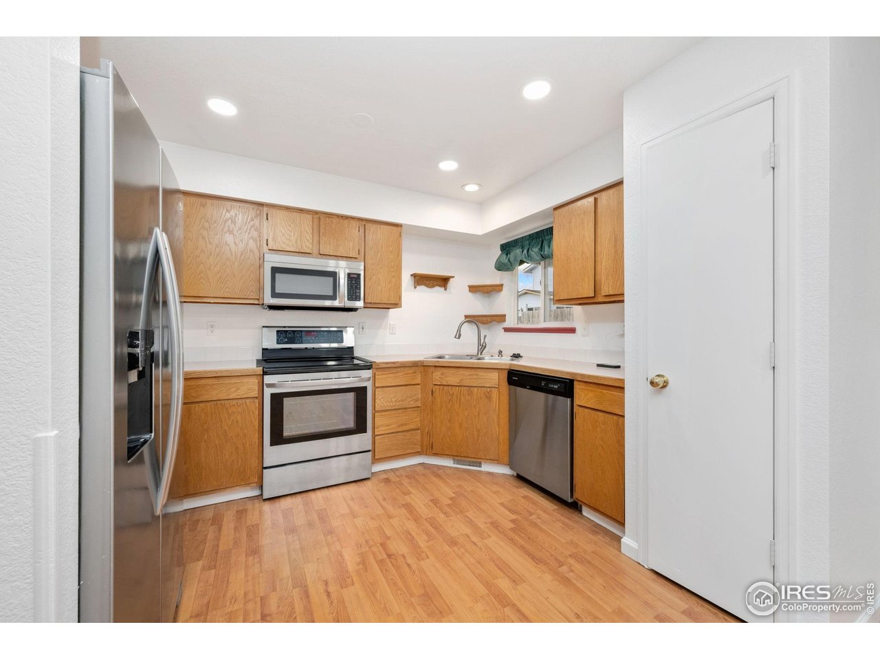 4616 Homestead Court Greeley, CO 80634 - Photo 8 of 22 a kitchen with a refrigerator stove and microwave