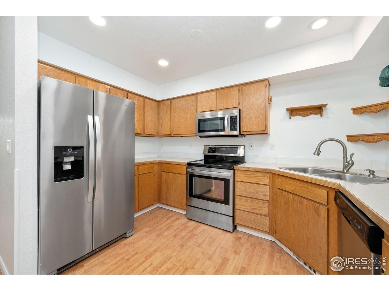 4616 Homestead Court Greeley, CO 80634 - Photo 9 of 22 a kitchen with stainless steel appliances granite countertop a refrigerator stove top oven a sink and dishwasher