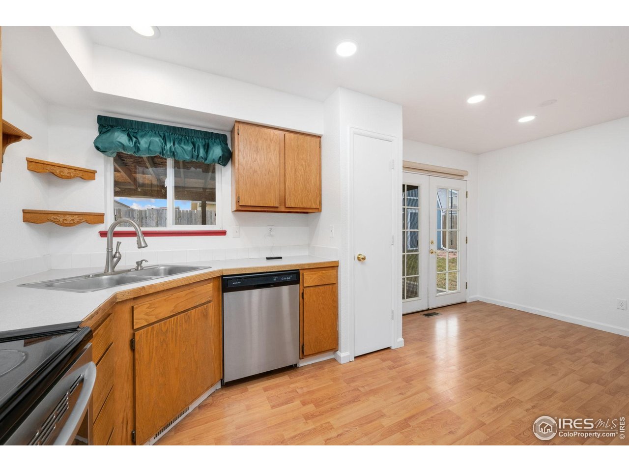 4616 Homestead Court Greeley, CO 80634 - Photo 10 of 22 a open kitchen with granite countertop a sink window and cabinets