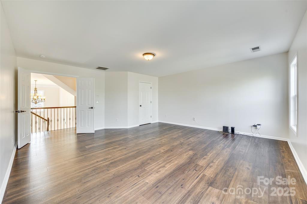 4005 Sedgewick Road Indian Trail, NC 28079 - Photo 22 of 38 a view of an empty room with wooden floor and a window