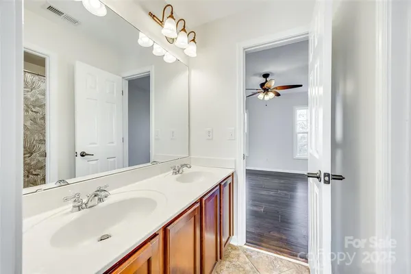 a bathroom with a sink a mirror and shower