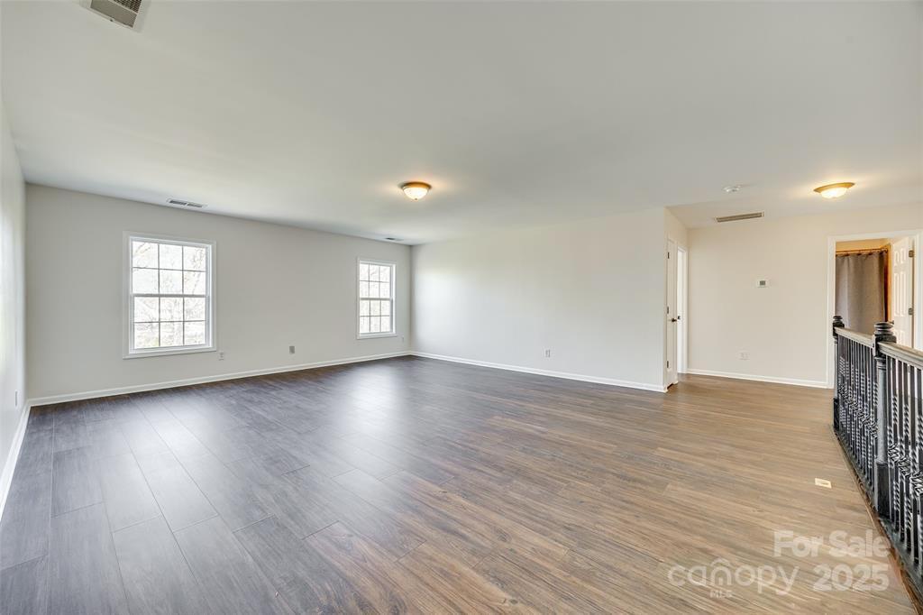 4005 Sedgewick Road Indian Trail, NC 28079 - Photo 30 of 38 an empty room with wooden floor and windows