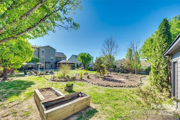a view of a backyard with plants and patio