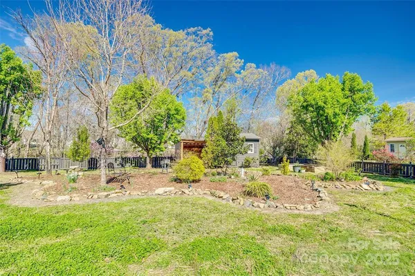 a view of a house with a yard and sitting area